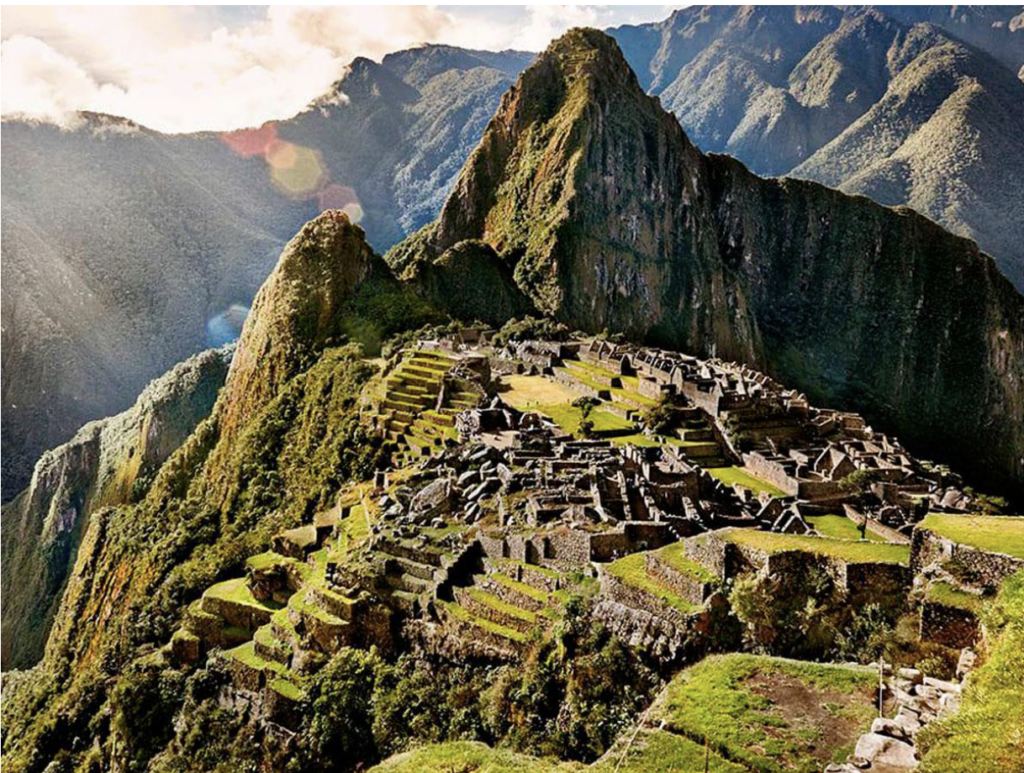 An above ground view on Machu Picchu during the daytime with lots of greenery 